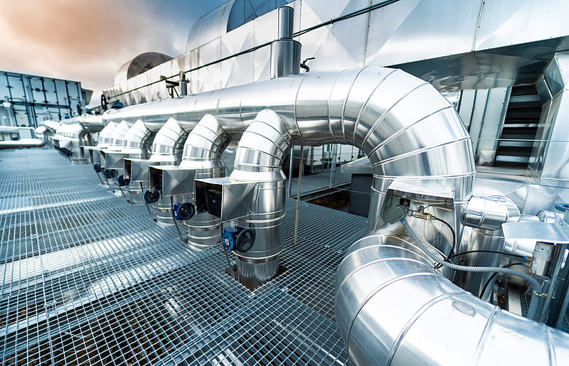 Close-up of industrial HVAC ductwork and controls, highlighting precision and system quality.